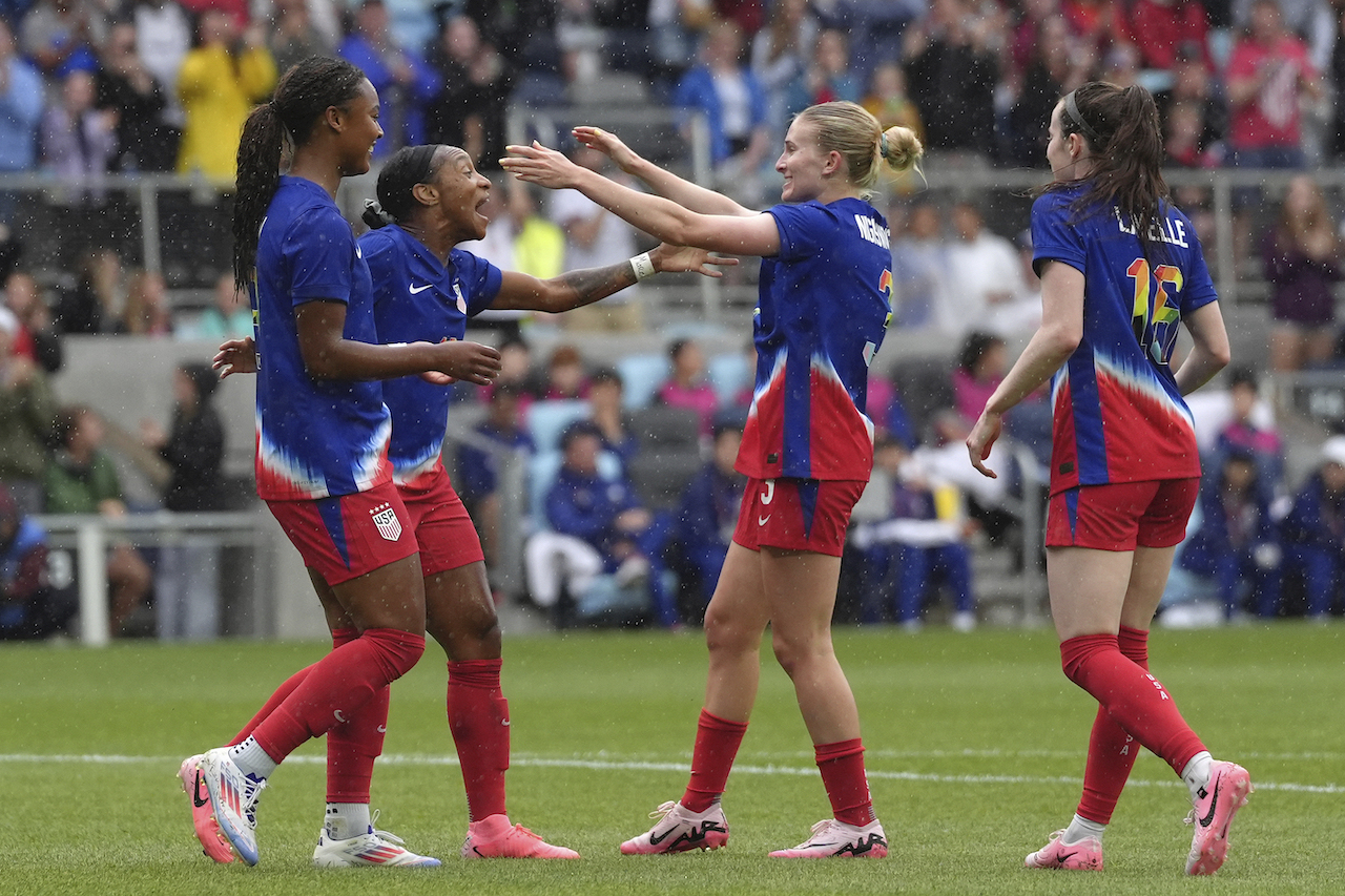 US forward Crystal Dunn, middle left, celebrates with teammates after scoring during the first half of an international friendly soccer against South Korea in St. Paul, Minn., Tuesday. (AP)