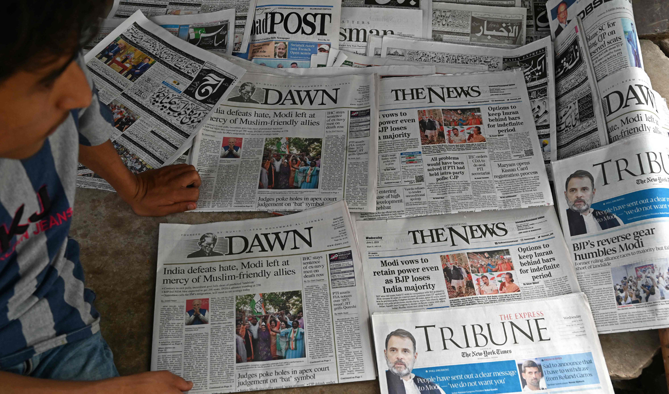 Pakistan’s newspapers with front page of India’s general election results are pictured along a street in Islamabad on June 5, 2024. (AFP)