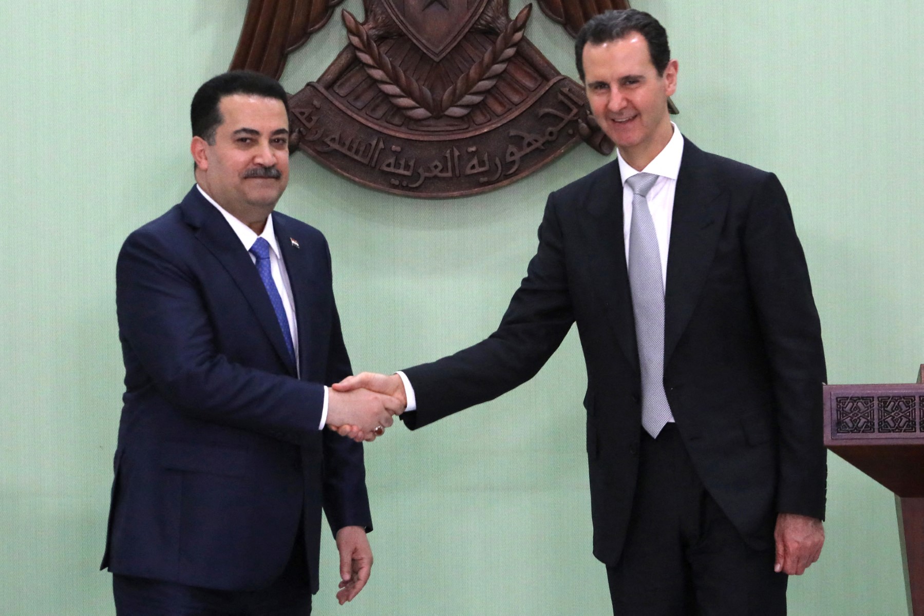 Syria's President Bashar al-Assad (R) shakes the hand of Iraq's Prime Minister Mohamed Shia al-Sudani ahead of a press conference in Damascus on July 16, 2023. (AFP)