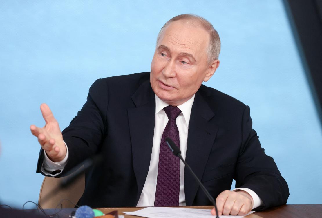 In this pool photograph distributed by Russian state agency Sputnik, Russia’s President Vladimir Putin speaks with heads of International news agencies in Saint Petersburg on June 5, 2024. (AFP)