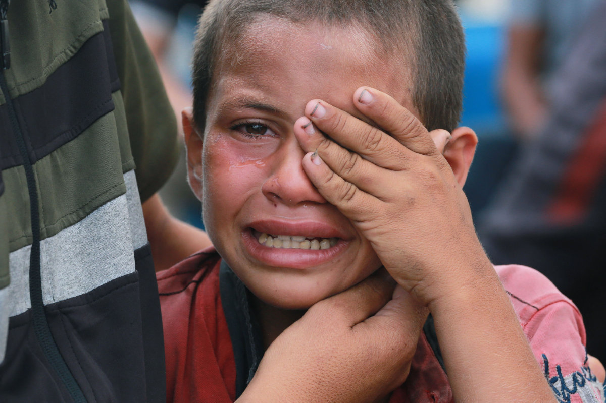 A displaced Palestinian boy weeps during a funeral rite on June 3, 2024, for his father, killed by an Israeli airstrike the previous night in the central Gaza Strip. (AFP)