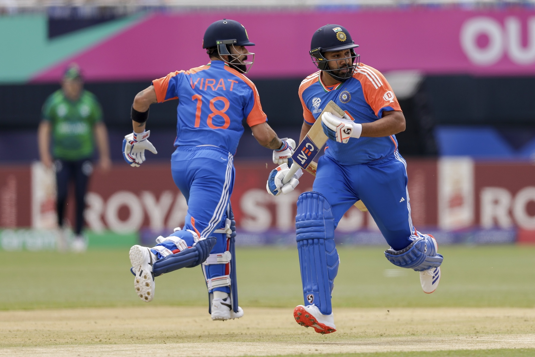 India's captain Rohit Sharma, right, and partner Virat Kohli run between wickets to score against Ireland during an ICC Men's T20 World Cup cricket match at the Nassau County International Cricket Stadium in Westbury, New York, Wednesday. (AP)