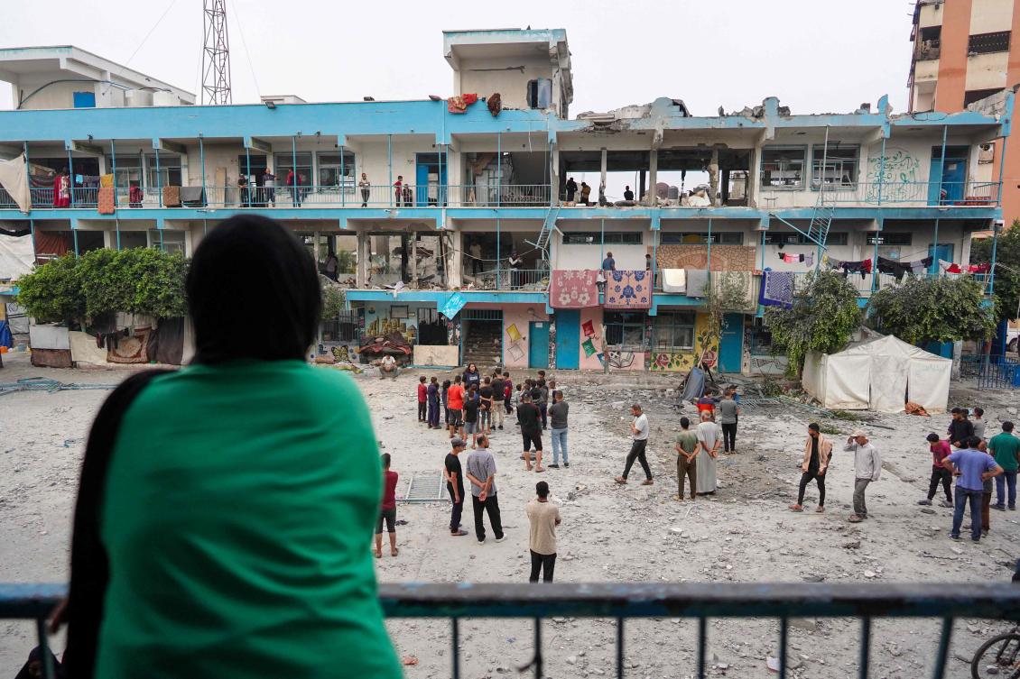 Palestinians check a UN-school housing displaced people that was hit during Israeli bombardment in Nuseirat, in the central Gaza Strip, on June 6, 2024, amid the ongoing conflict between Israel and the Palestinian Hamas militant group. (AFP)