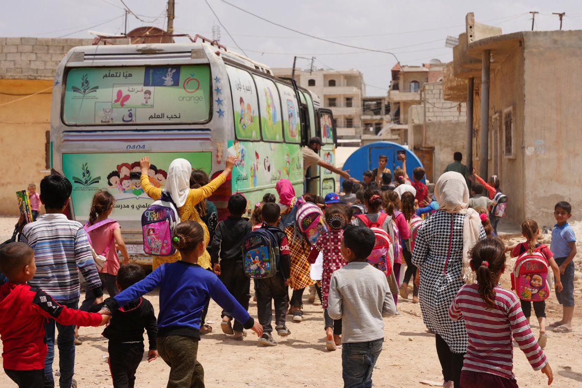 File photo showing pupils boarding a school bus at a camp for internally displaced persons in Jindayris in the rebel-held northwestern Syrian province of Aleppo on May 23, 2023. (AFP/File)