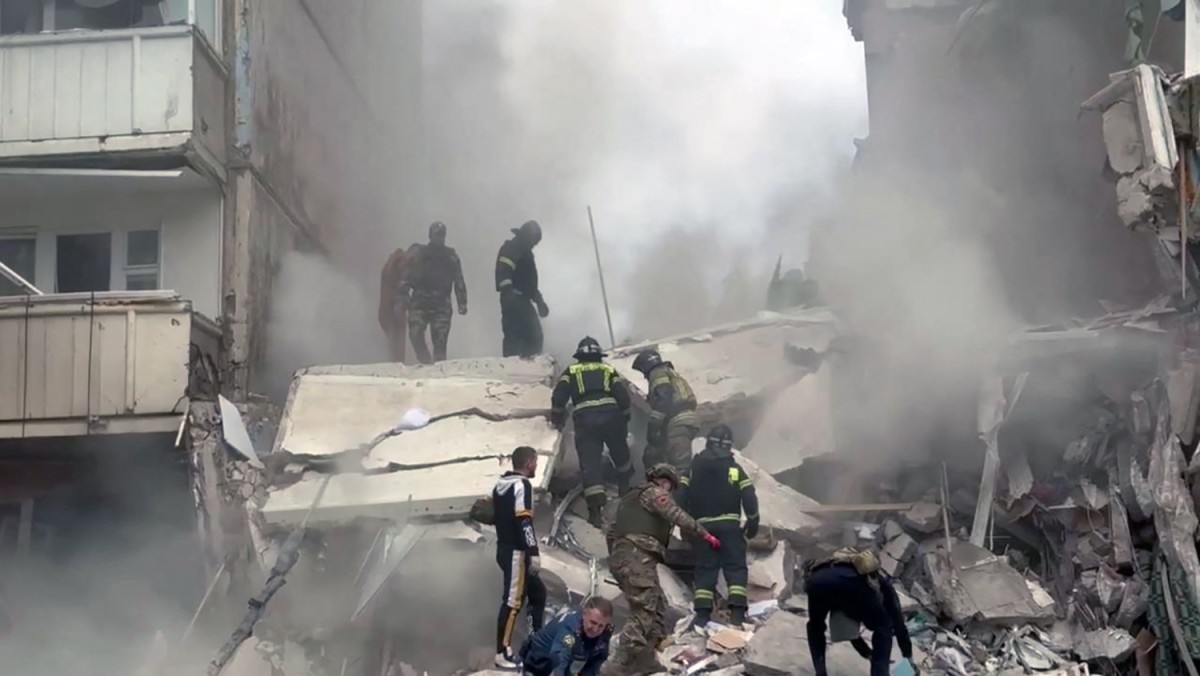 This handout photograph released on May 12, 2024, on the official Telegram account of the Belgorod region governor Vyacheslav Gladkov, shows firefighters operating on the site of an apartment building which partially collapsed after being damaged by a Ukrainian strike in Belgorod. (AFP)