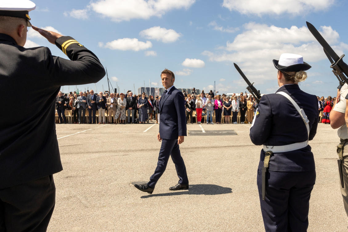 French President Emmanuel Macron reviews the troops during a commemorative ceremony in the city of Cherbourg, France. (Reuters)