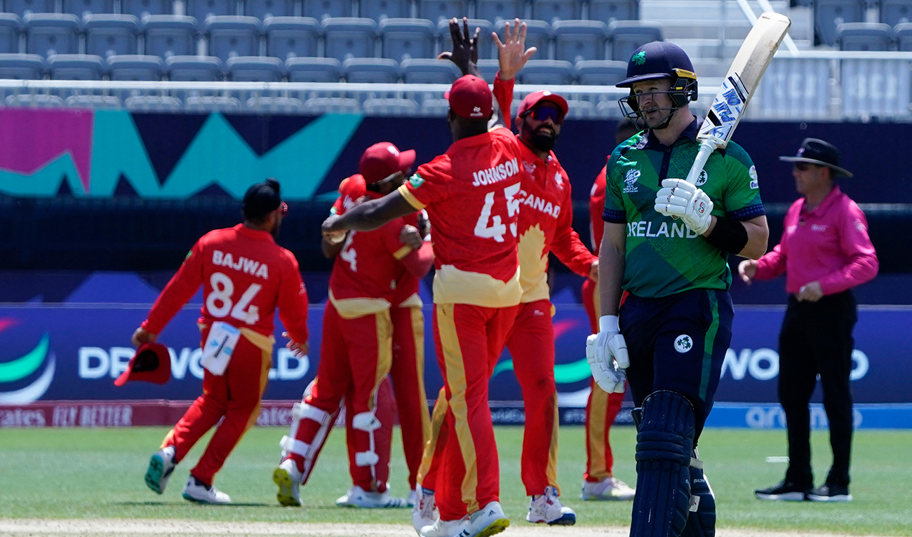 Ireland's Barry McCarthy walks away as Canada celebrates winning the ICC men's Twenty20 World Cup 2024 group A cricket match between Canada and Ireland at the Nassau County International Cricket Stadium in East Meadow, New York, on June 7, 2024. (AFP)