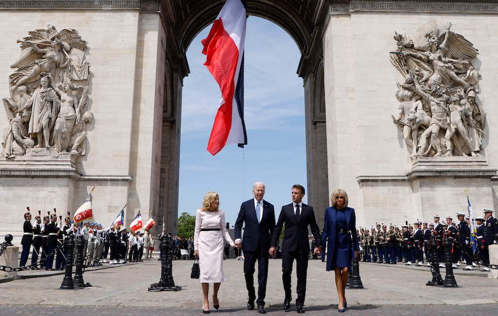 France’s president Emmanuel Macron, second right, and US president Joe Biden, second left, with their spouses Brigitte Macron, right, and Jill Biden walk hand in hand at Arc de Triomphe in Paris on June 8, 2024. (AFP)
