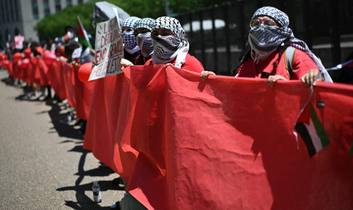 Pro-Palestinian demonstrators, in formation holding a "red line," rally near the White House in Washington, DC, on June 8, 2024 to protest against Israel's actions in Gaza. (AFP)