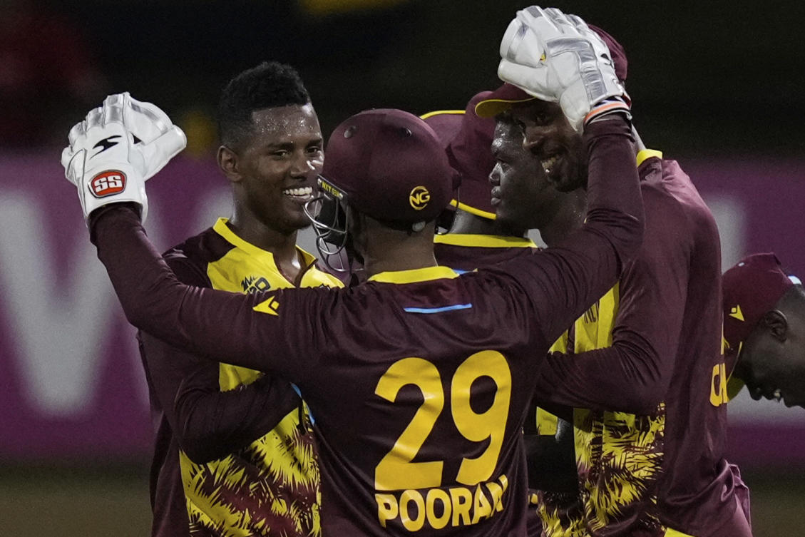 West Indies’ Akeal Hosein, left, celebrates with teammates after their 134-run victory over Uganda during an ICC Men’s T20 World Cup cricket match at Guyana National Stadium in Providence, Guyana on June 8, 2024. (AP)