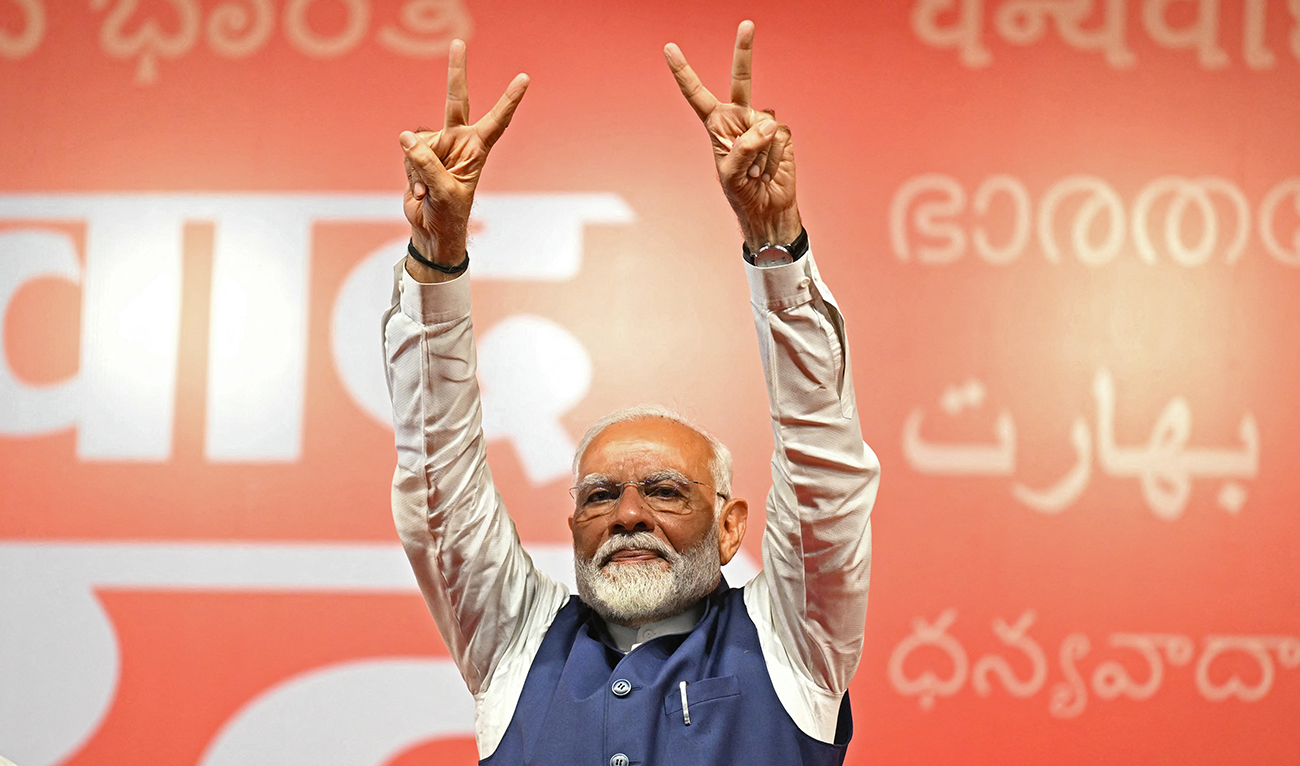 India’s Prime Minister Narendra Modi flashes victory sign at the Bharatiya Janata Party (BJP) headquarters to celebrate the party’s win in country's general election, in New Delhi on June 4, 2024. (AFP/File)