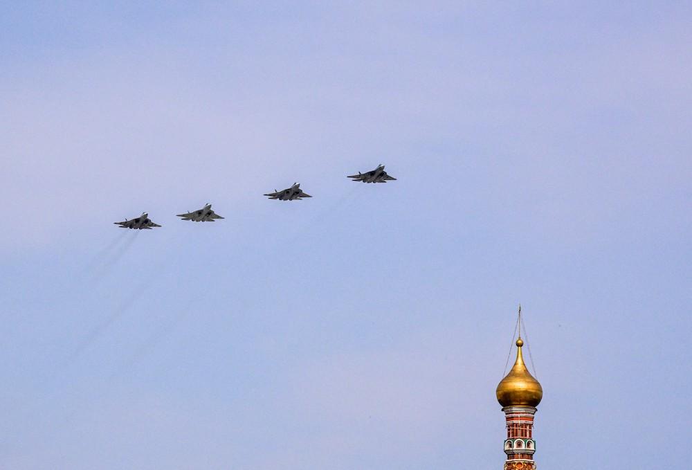 Above, Russian Sukhoi Su-57 fifth-generation fighter aircraft fly over Red Square during the general rehearsal of the Victory Day military parade in central Moscow on May 7, 2022. (AFP)