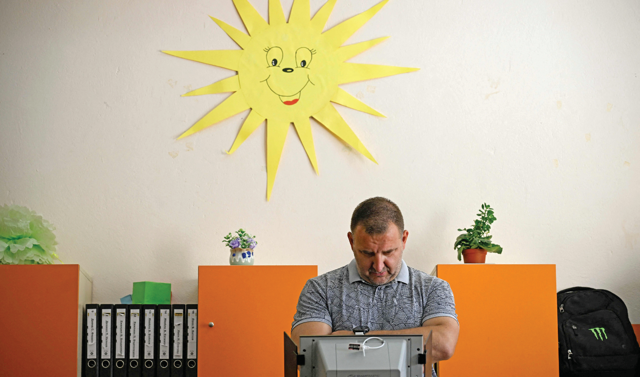 A man casts his ballot as he votes during parliamentary and European Parliament elections at a polling station in Sofia Sunday. (AFP)
