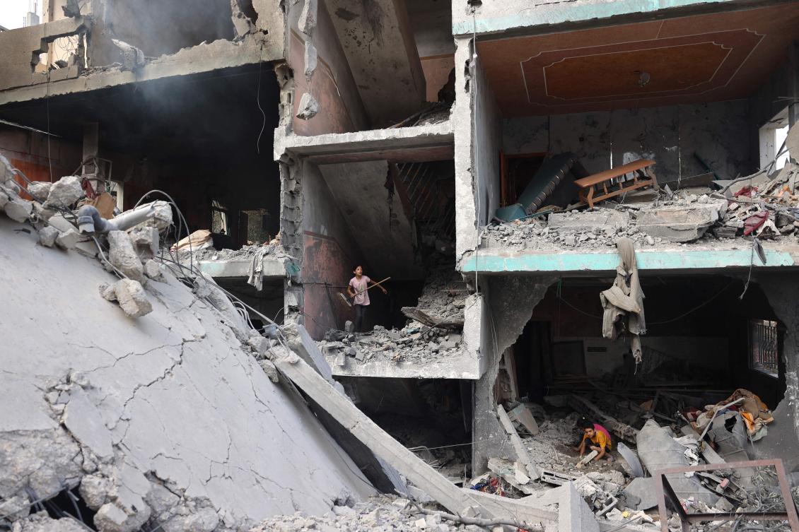 Palestinians children search through the rubble of their home a day after an operation by the Israeli military at the Nuseirat camp in the central Gaza Strip on June 9, 2024. (AFP)
