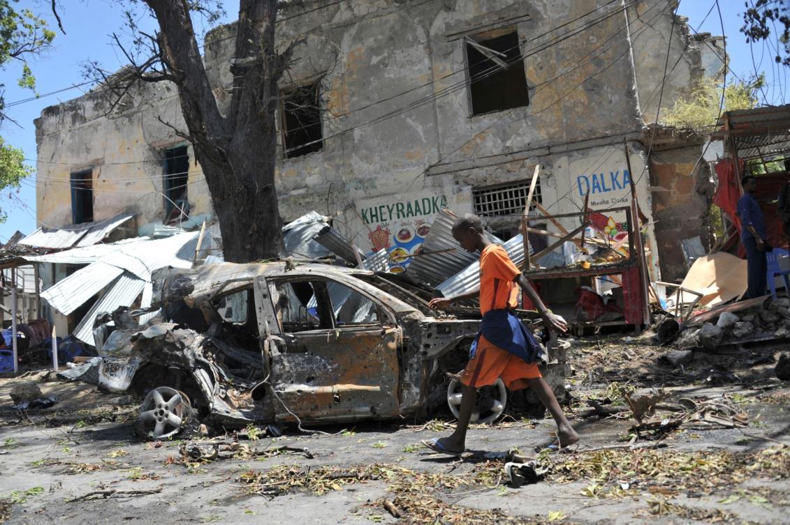 A file photo shows a boy walking past the site of a car bomb attack near a security checkpoint in the Somali capital, in Mogadishu on March 7, 2019. (AFP)
