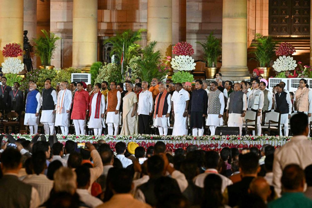Narendra Modi, left, and newly appointed ministers are sworn in at the presidential palace in New Delhi on June 9, 2024. (AFP)