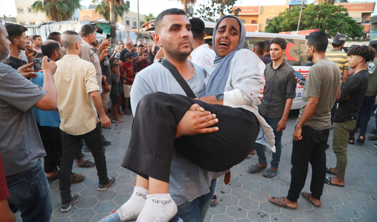Palestinians wounded in the Israeli bombardment of the besieged Gaza Strip are brought to Al-Aqsa Hospital in Deir Al-Balah. (AP)