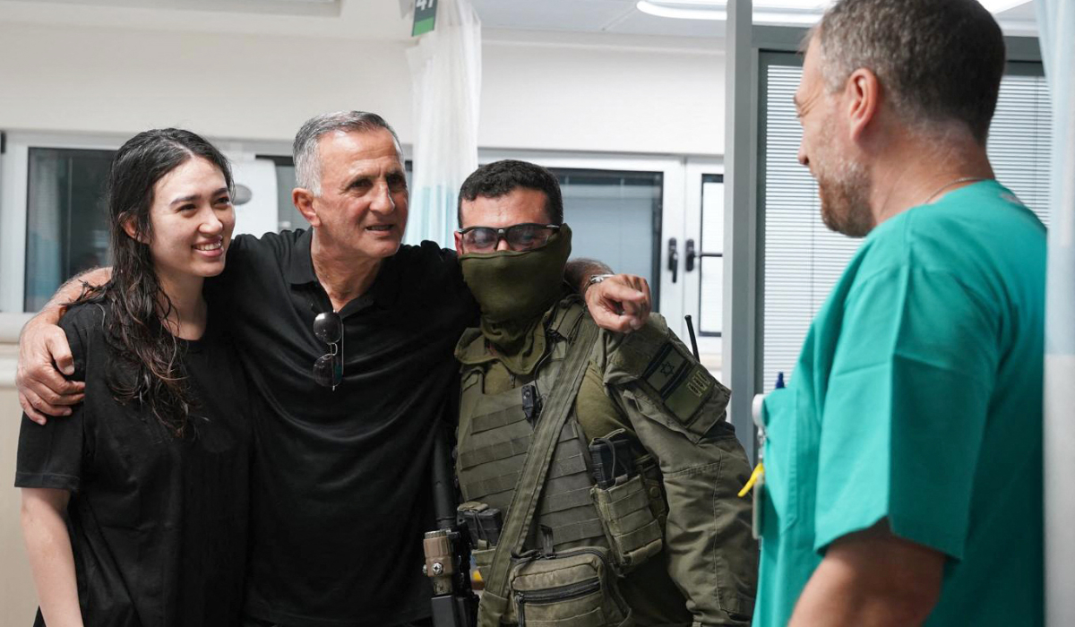 This handout picture released by the Israeli Army on June 8, 2024, shows Noa Argamani (L), 26-years-old, being standing next to a relative (2nd L) at the Sheba Tel-HaShomer Medical Centre, after her rescue from the Gaza Strip by the Israeli army, in Ramat Gan near Tel Aviv on June 8, 2024, amid the ongoing conflict in the Palestinian territory between Israel and the militant group Hamas. (AFP)