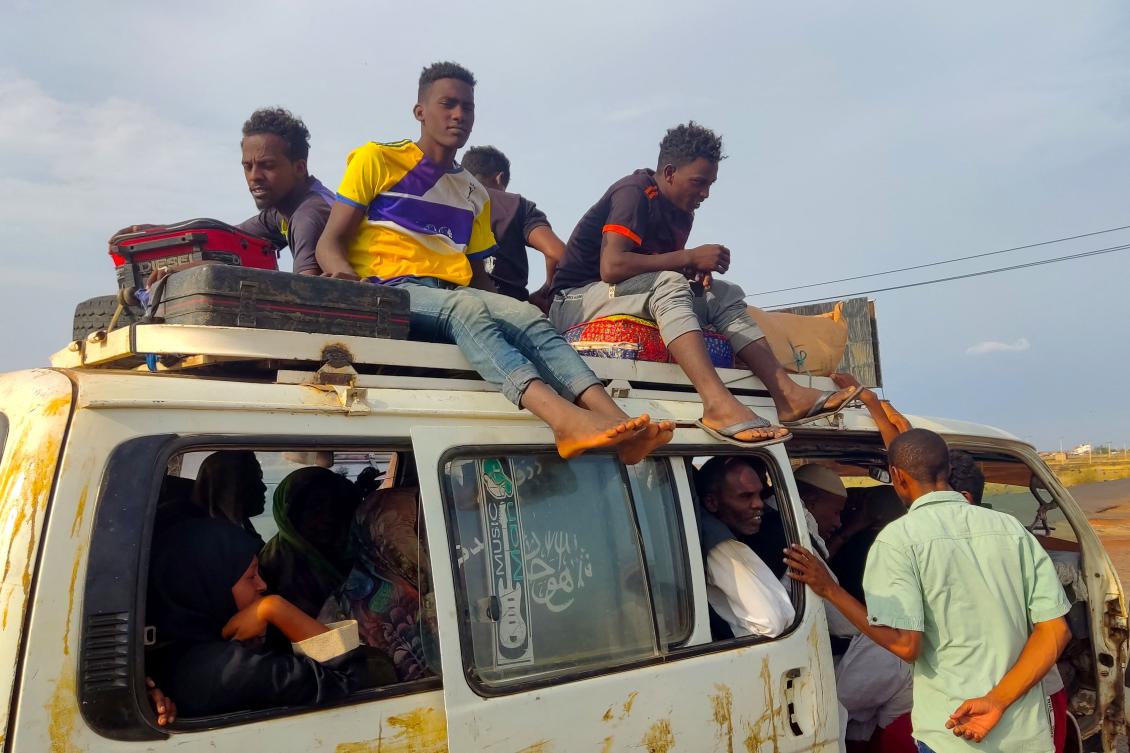Peolpe displaced from Sudan's Jazira state arrive in packed vehicles to the entrance of the eastern city of Gedaref on June 10, 2024, amid the ongoing conflict between the Sudanese army and the paramilitary Rapid Support Forces (RSF). (Photo by AFP)