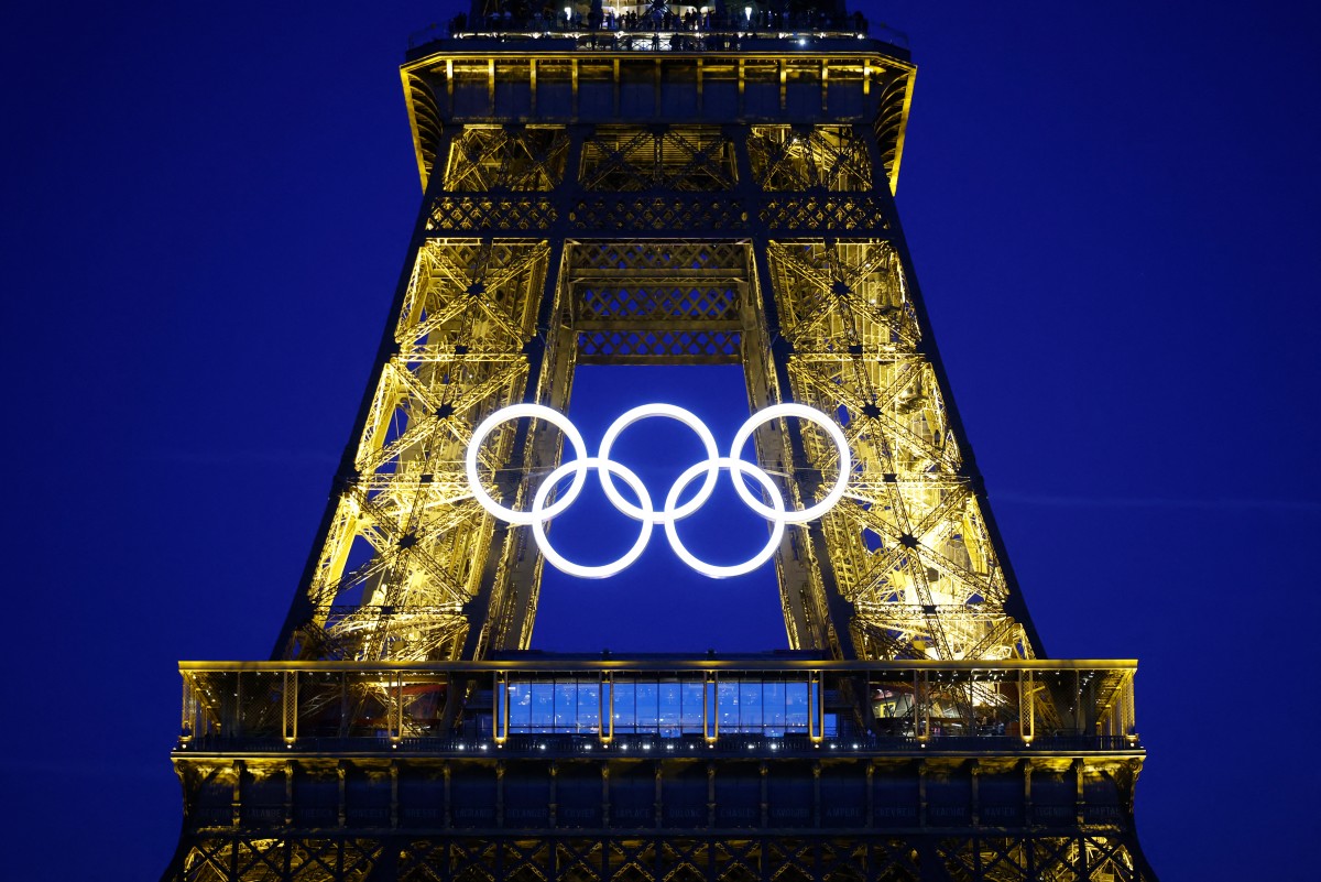 The Olympic rings are illuminated on the Eiffel Tower on June 7, 2024, ahead the upcoming Paris 2024 Olympic Games.(AFP)