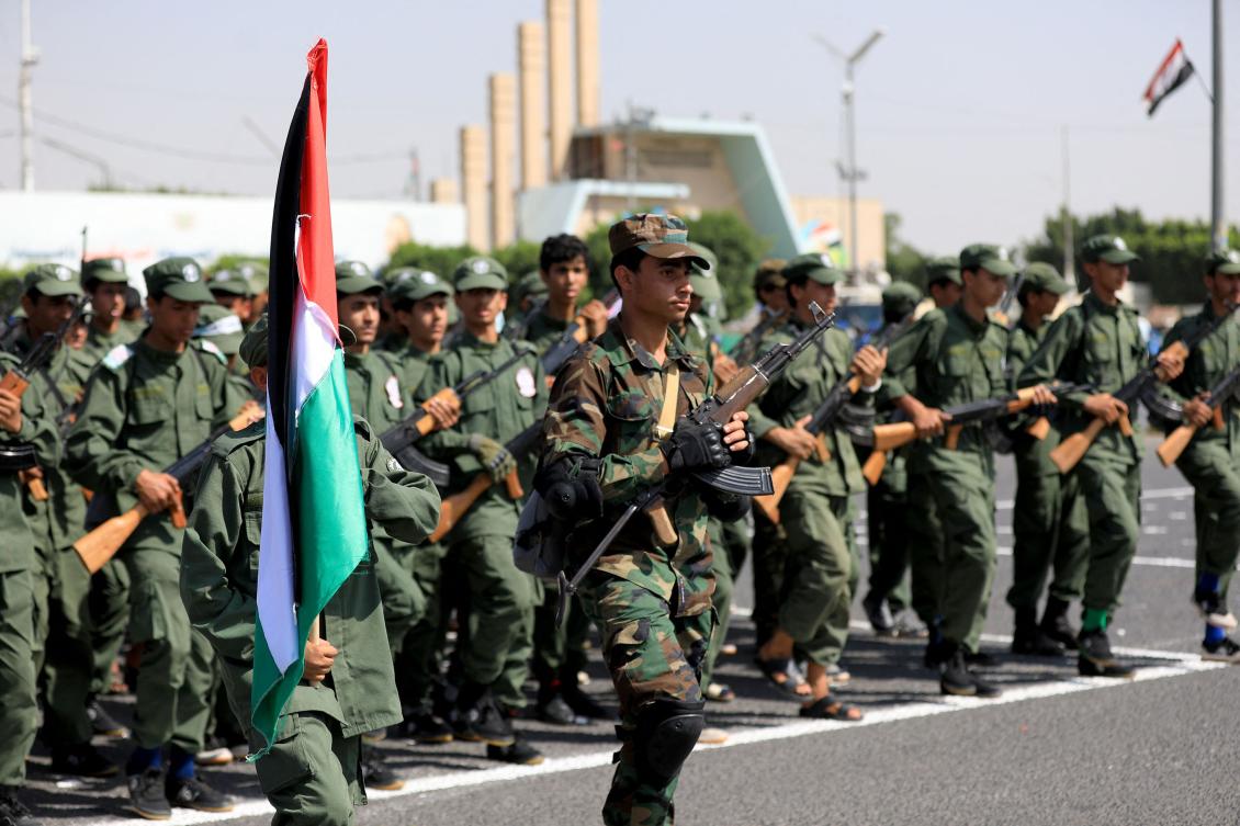 Yemeni youths march during a ceremony in the capital Sanaa marking the end of summer camps organized by the country’s Houthi militia, on June 9, 2024. (AFP)