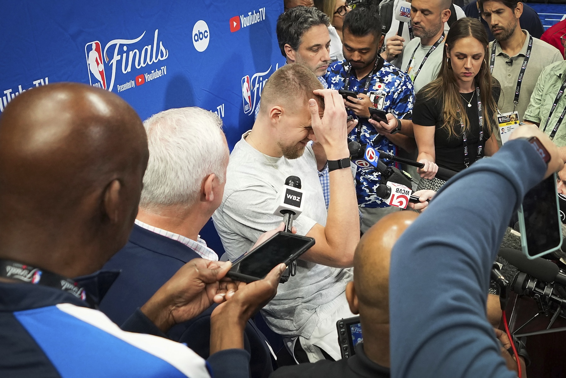 Boston Celtics center Kristaps Porzingis is surrounded by media before basketball practice Tuesday in Dallas, in preparation for Game 3 of the NBA Finals against the Dallas Mavericks. (AP)