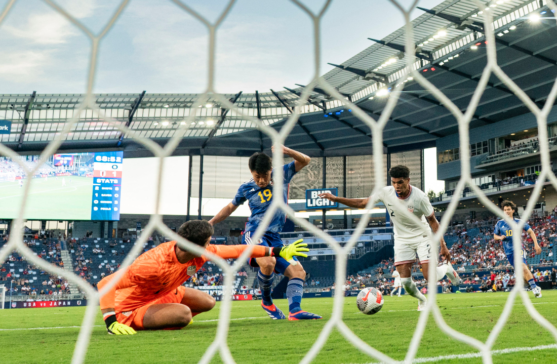 Japan forward Mao Hosoya (19) scores a goal against US defender Nathan Harriel (2) and goalkeeper Patrick Schulte (1) during the second half of an under-23 game at Children’s Mercy Park in Kansas City. (USA TODAY Sports)