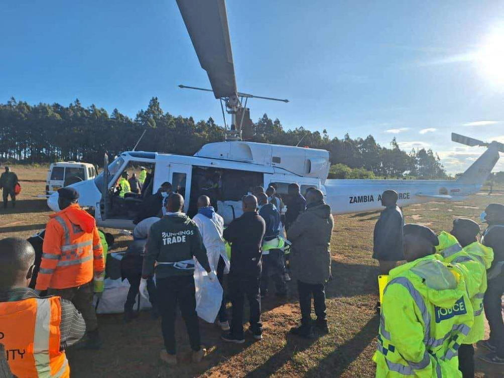 Workers load body bags believed to be those of Malawi’s Vice President Saulos Klaus Chilima and nine others to a Zambia Air Force AB-212 helicopter on June 11, 2024. (Zambia Air Force via Reuters)