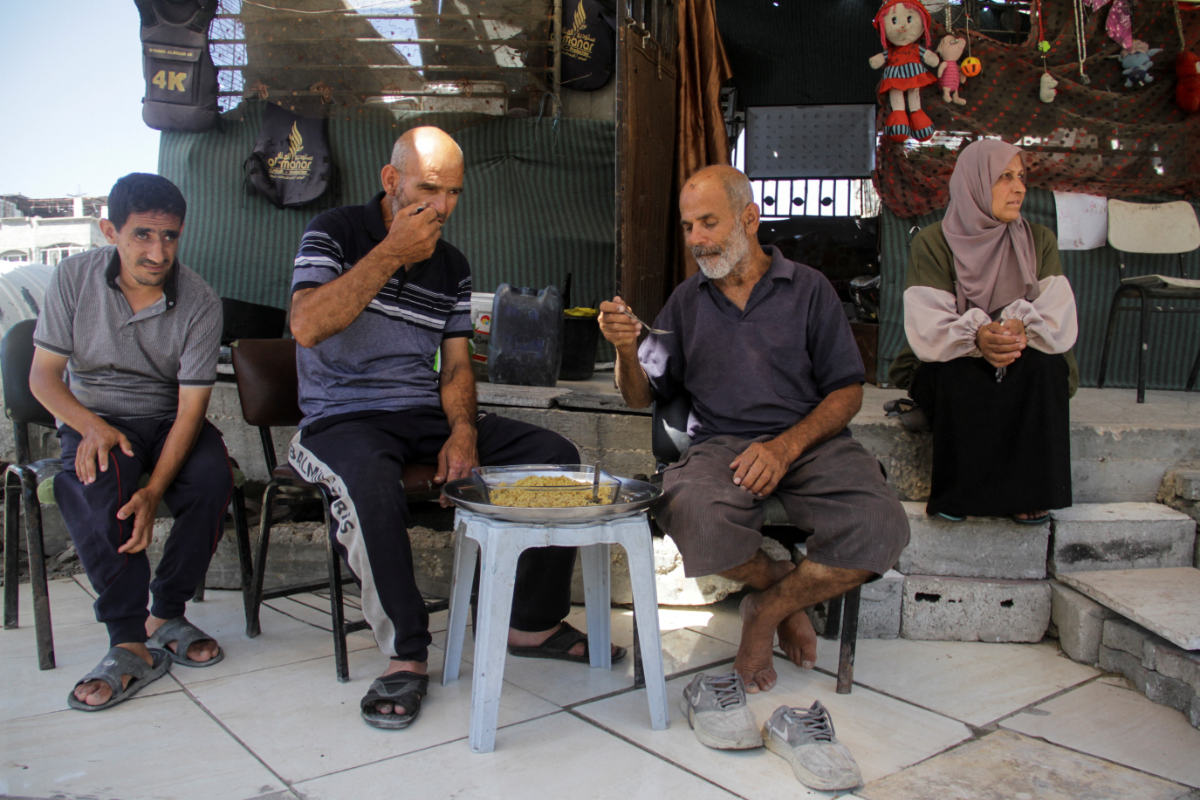 Palestinian sit at a makeshift home, amid the ongoing conflict between Israel and Hamas, in Beit Lahia in the northern Gaza Strip, on June 12, 2024. (REUTERS)