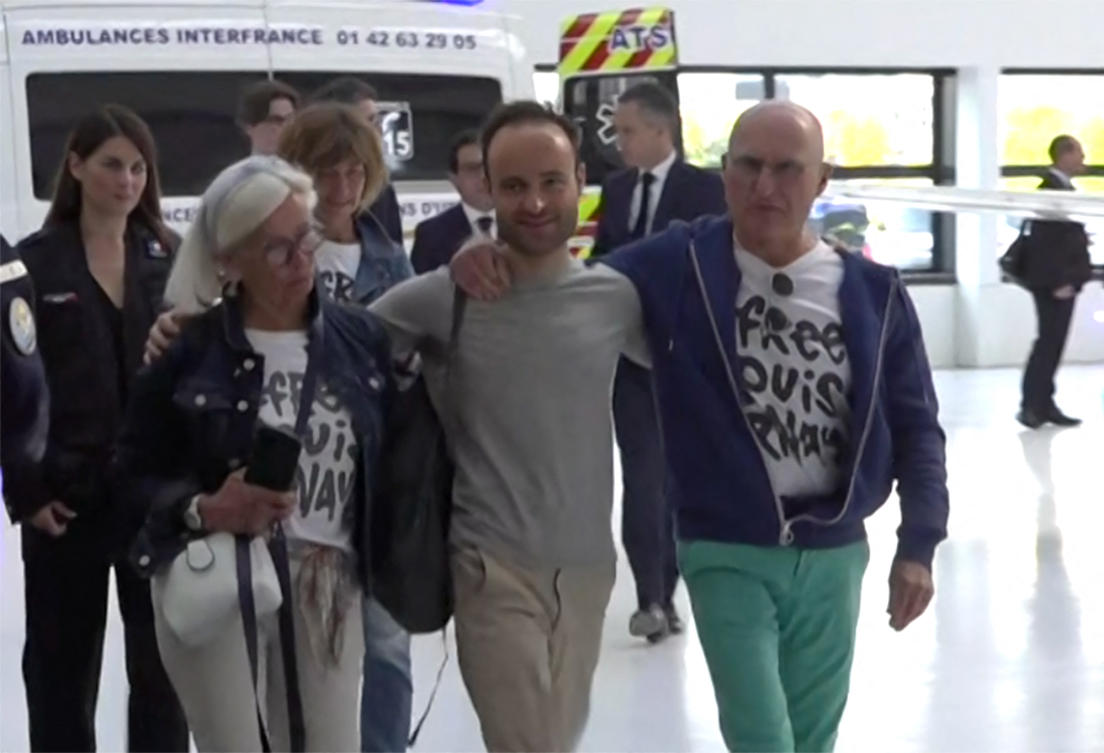 French citizen Louis Arnaud flanked by his mother and father upon arrival at Le Bourget airport, north of Paris, on June 13, 2024, after his release from custody in Iran. (AFP)
