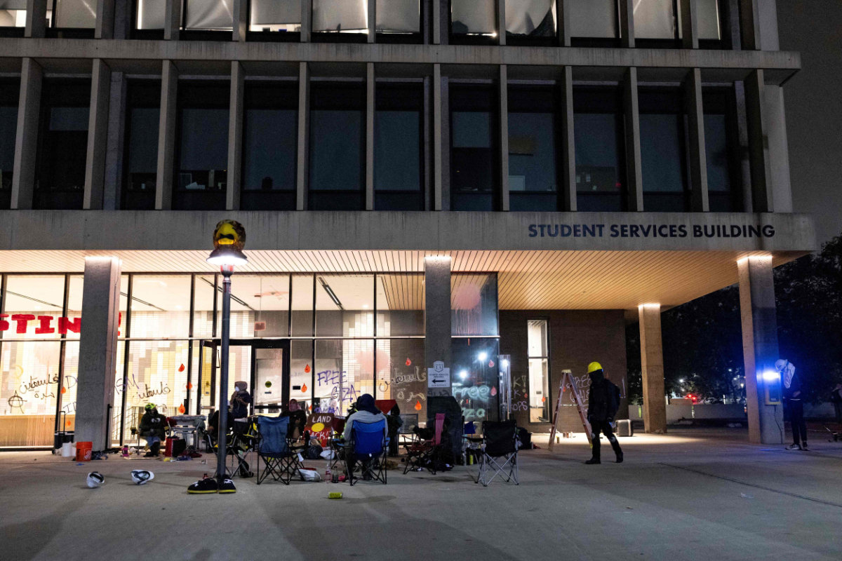 Pro-Palestinian protester block the entrance of the California State University Los Angeles (CSULA) Student Services Building in Los Angeles on June 12, 2024. (AFP)