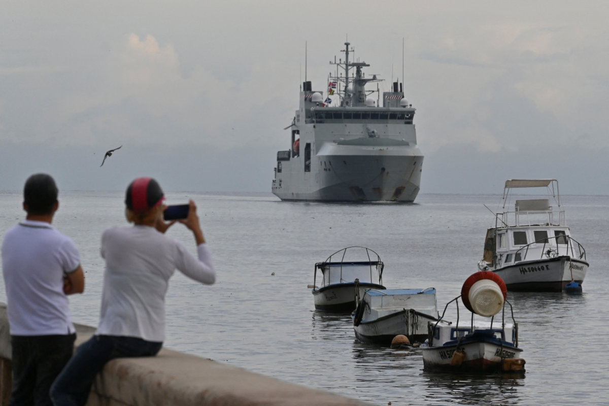 People take pictures of the Canadian Navy patrol boat HMCS Margaret Brooke as it enters Havana's bay, Cuba, on June 14, 2024. (REUTERS)