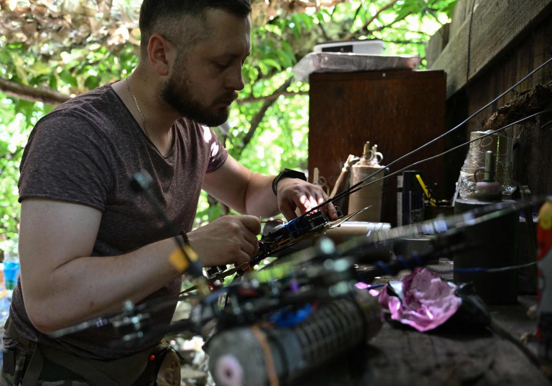 Under-resourced Ukrainian forces have been ceding village after village to determined Russian attacks. Above, a Ukrainian serviceman prepares an FPV drone to launch toward Russian positions in the Donetsk region on June 10, 2024. (AFP)