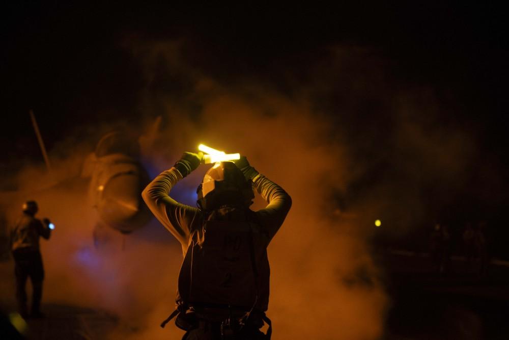 The US and its allies have been conducting flight operations in response to increased Houthi attacks in the Red Sea. Above, USS Dwight D. Eisenhower crew members prepare for nighttime sorties on January 22, 2024 against the Houthis. (AFP)