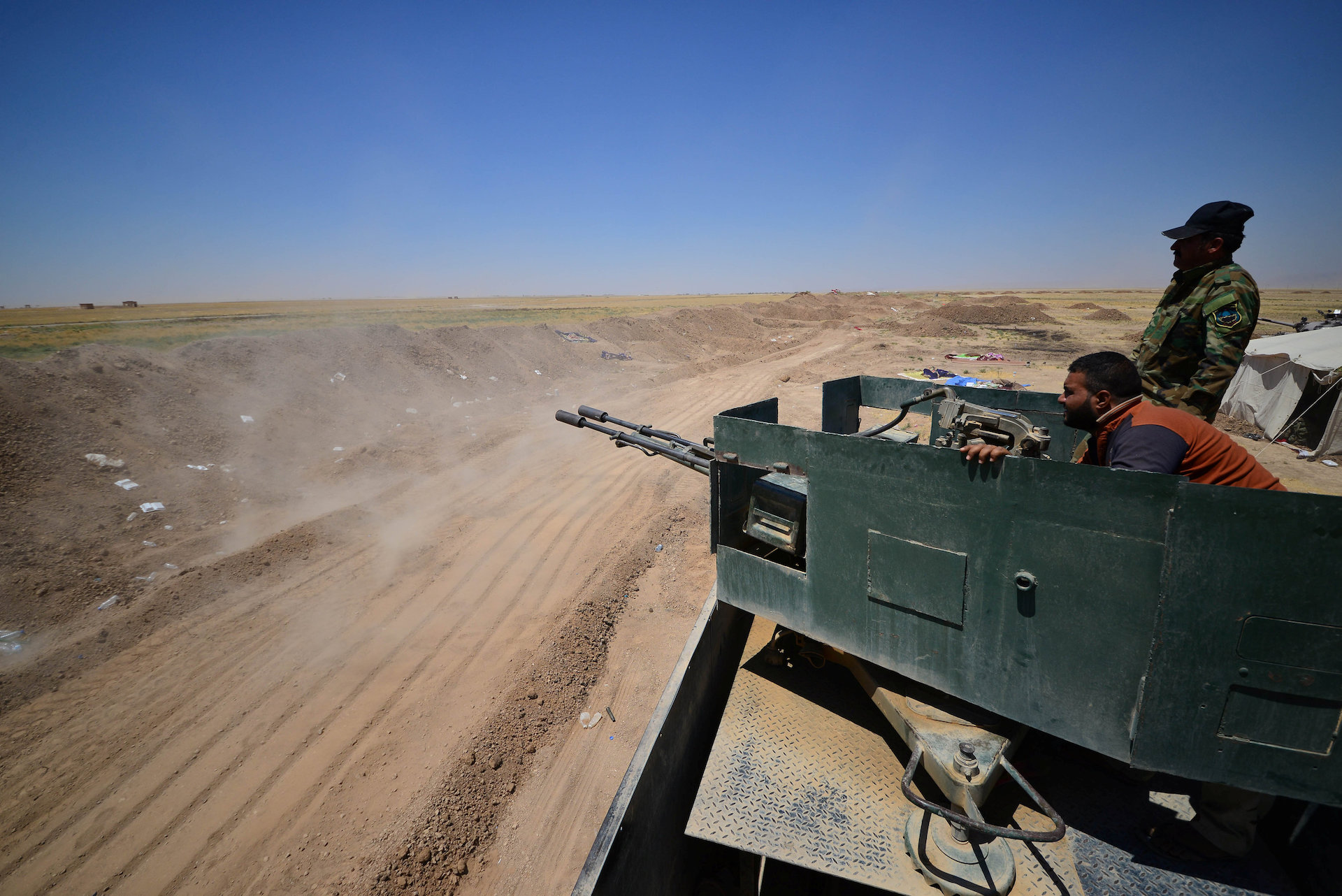 Popular Mobilization Forces (PMF) ride in a military vehicle on the Iraqi border with Syria, west of Mosul, Iraq June 12, 2017. Picture taken June 12, 2017. (Reuters)