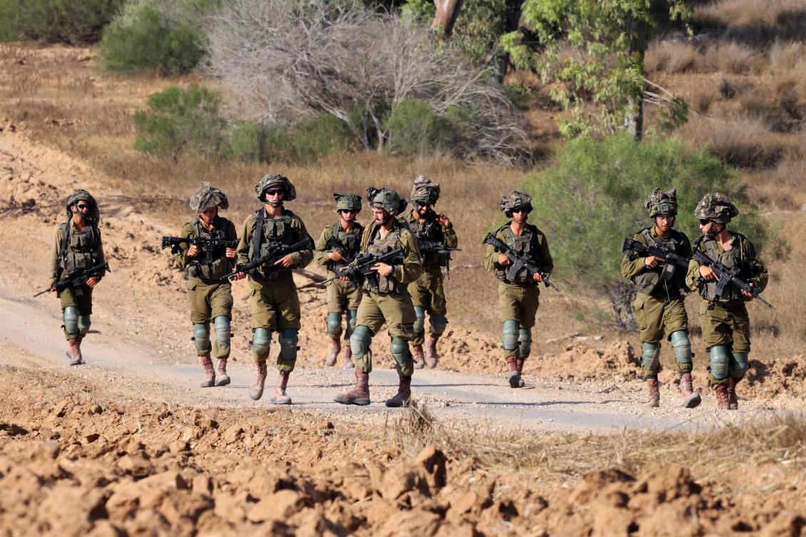 Israeli army soldiers patrol around a position along Israel’s southern border with the Gaza Strip on Jun. 13, 2024, amid the ongoing conflict between Israel and Hamas. (AFP)