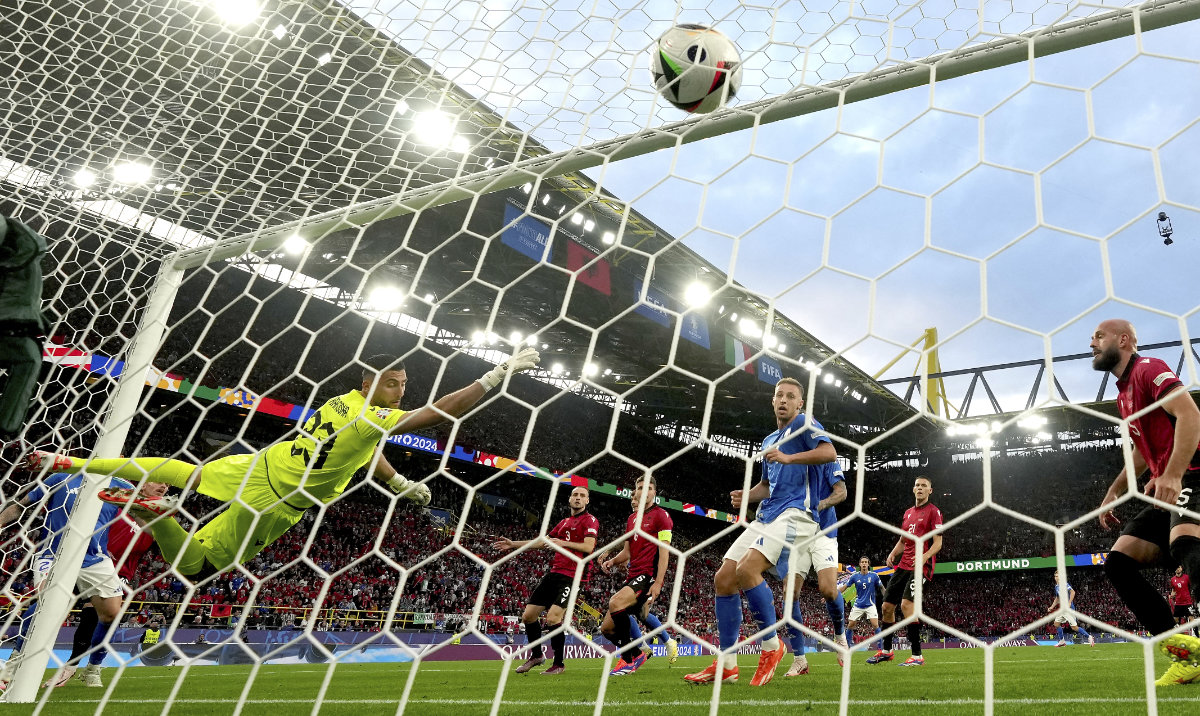 Italy's Alessandro Bastoni, left, scores his side's opening goal during a Group B match between Italy and Albania at the Euro 2024 soccer tournament in Dortmund, Germany, Saturday, June 15, 2024. (AP)