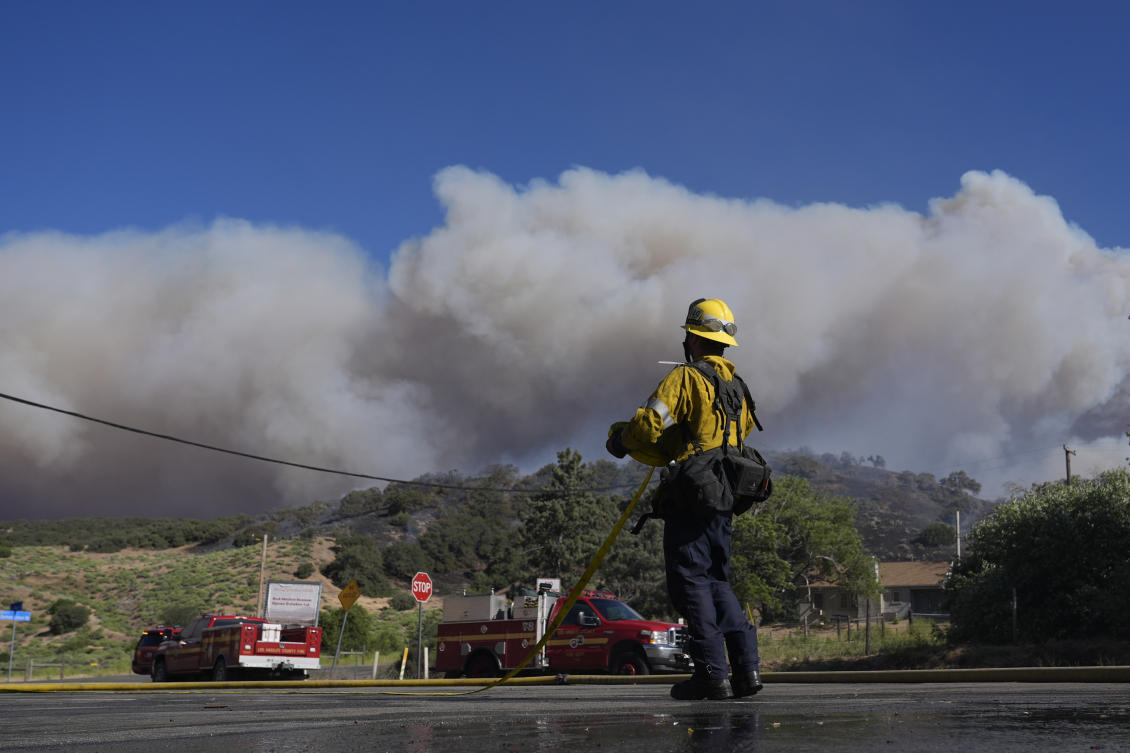 A firefighter watches a plume of smoke from the Post Fire on June 15, 2024 in Gorman, California. (AP)