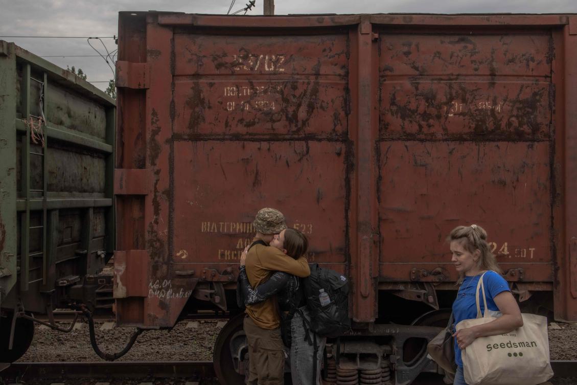 A Ukrainian serviceman hugs his partner who arrived on a train from Kyiv, at a railway station in Kramatorsk, Donetsk region on June 15, 2024. (AFP)