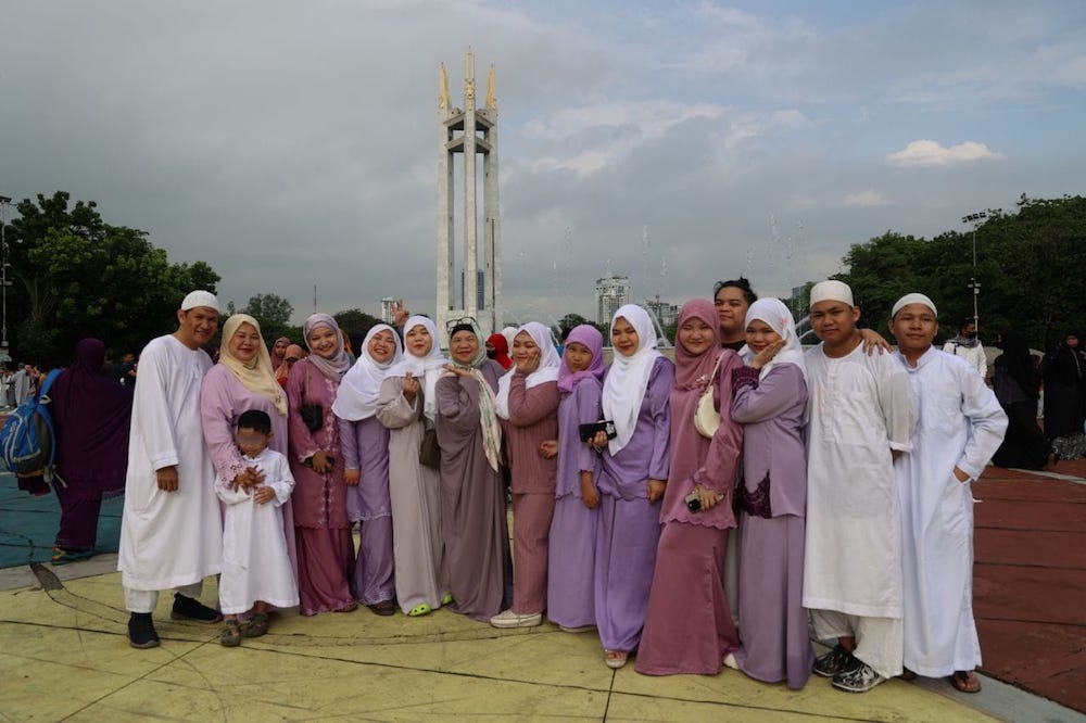 A Filipino Muslim family pose for a photo at the celebration of Eid Al-Adha at the Quezon Memorial Circle in Quezon City on June 16, 2024. (Quezon City Government)