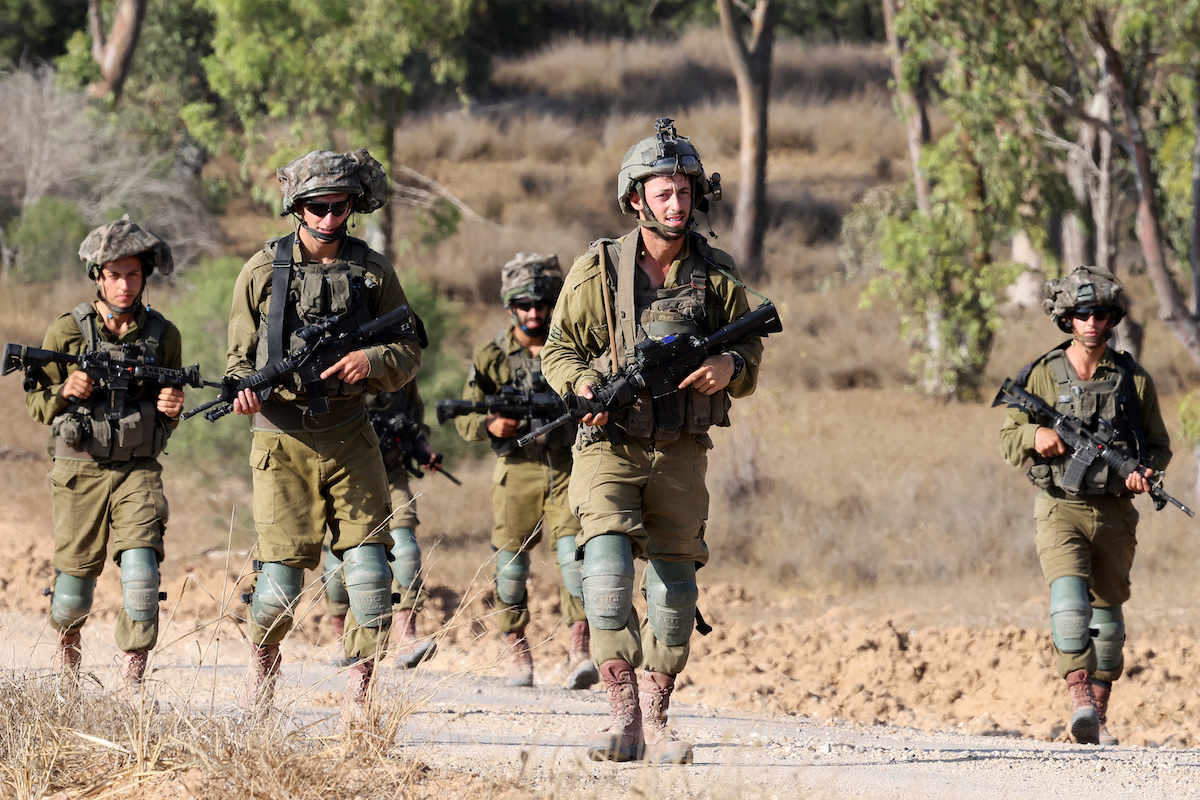 Israeli army soldiers patrol around a position along Israel's southern border with the Gaza Strip on June 13, 2024. (File/AFP)