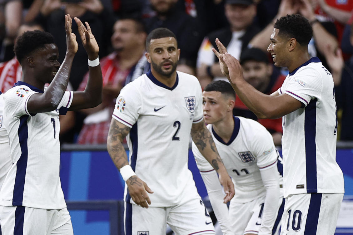 England’s midfielder Jude Bellingham (R) celebrates scoring the opening goal with his teammates including England’s forward #07 Bukayo Saka (L) during the UEFA Euro 2024 Group C football match between Serbia and England at the Arena AufSchalke in Gelsenkirchen. (AFP)