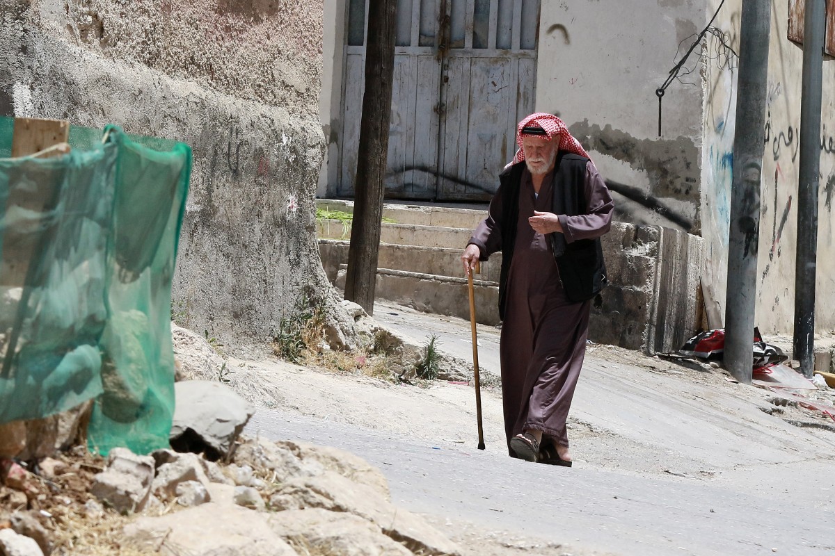 A man walks in a street in the Palestinian refugee camp of Baqa'a near Amman on May 22, 2024. (File/AFP)