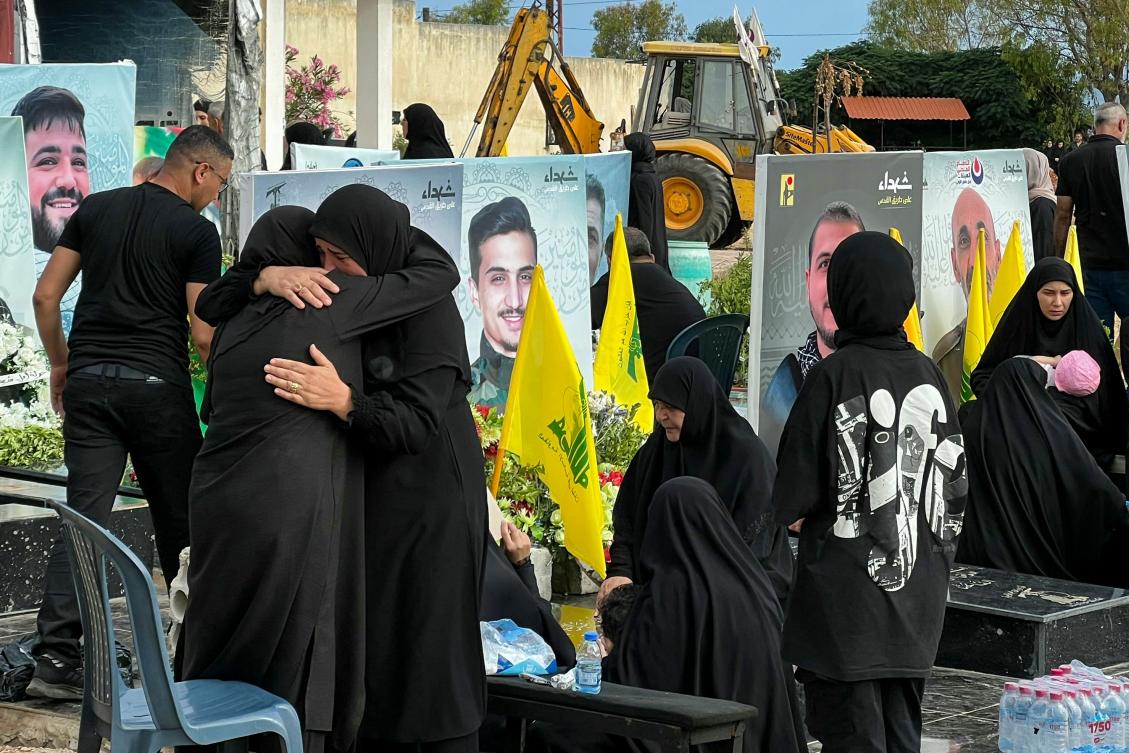 Relatives visit the graves of killed Hezbollah fighters during Eid Al-Adha, or the Feast of Sacrifice in the southern Lebanese town of Naqoura near the border with Israel on June 17, 2024. (AFP)