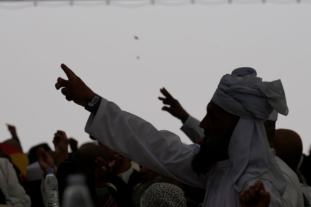 Muslim pilgrims cast stones at pillars in the symbolic stoning of the devil, the last rite of the annual Hajj, as it rains in Mina, near the holy city of Makkah, Saudi Arabia, Monday, June 17, 2024. (AP Photo)