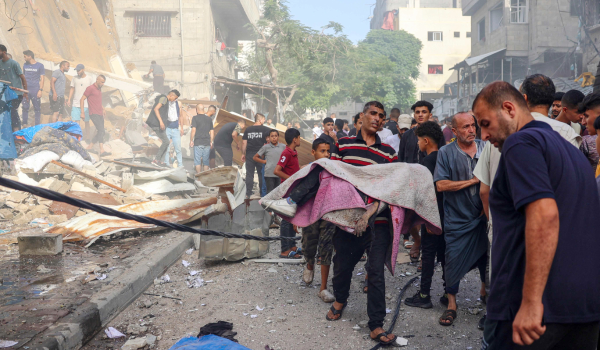 People search for survivors in the rubble of a building following Israeli bombardment at al-Bureij refugee camp in the central Gaza Strip on June 16, 2024, amid the ongoing conflict between Israel and the Palestinian militant group Hamas. (AFP)