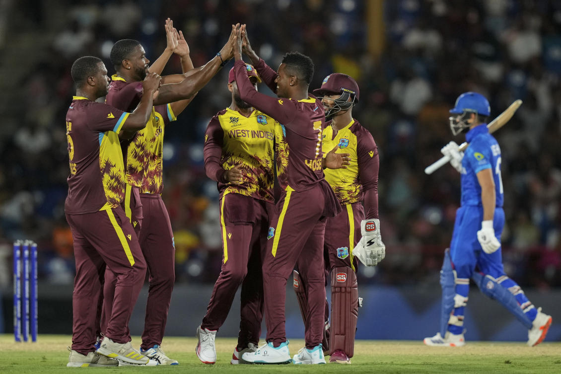 West Indies players celebrate the dismissal of Afghanistan’s Rahmanullah Gurbaz during their ICC Men’s T20 World Cup cricket matc in Gros Islet, Saint Lucia on June 17, 2024. (AP)