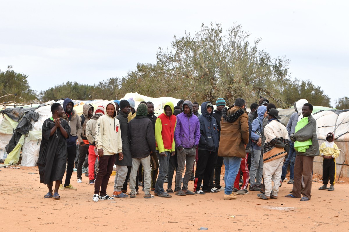 igrant from Sub-Saharian Africa gather gather near their tents at a camp in Jebeniana in Tunisia's Sfax governorate on April 24, 2024. (File/AFP)