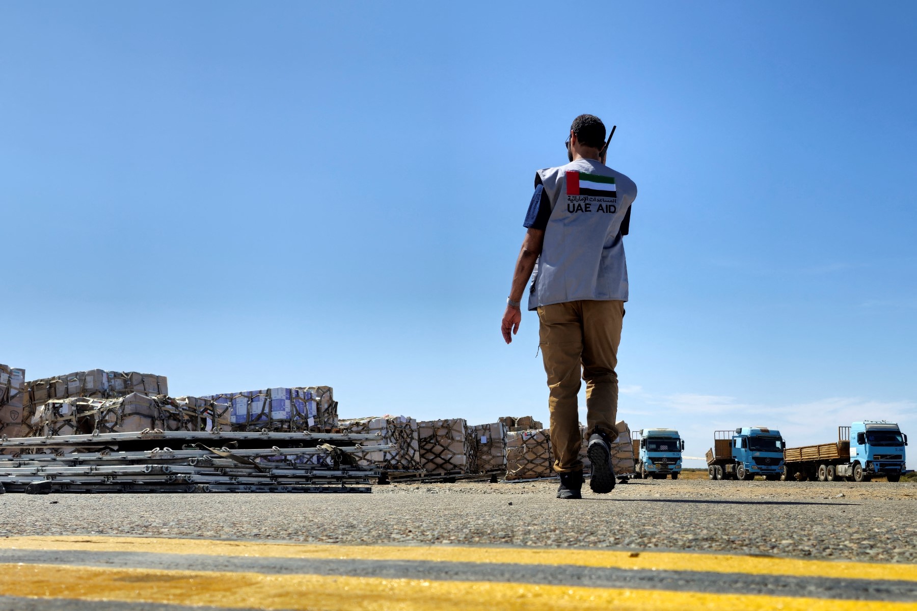 An worker coordinates the unloading of aid supplies upon the landing of an Emirati aircraft at Port Sudan airport on May 10, 2023. (File/AFP)