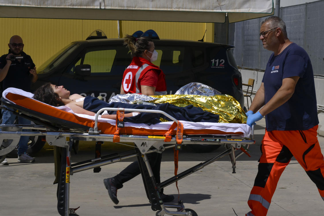 Some of the 11 migrants saved from the sea after their sailboat sank in the Mediterranean Sea between Italy and Greece on Jun. 17, 2024, are assisted in Roccella Ionica, southern Italy where they were brought by the Italian Coast Guard. (AP)